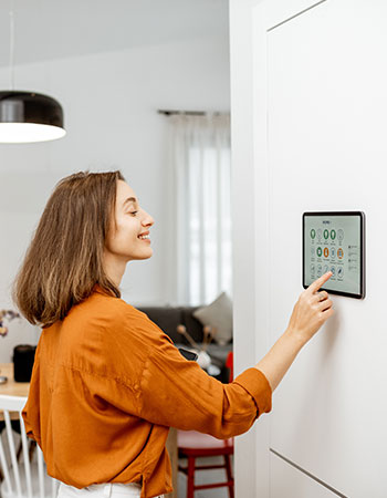 Smart home control panel being operated by a person.